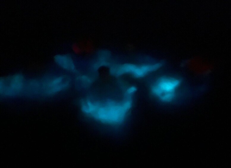 A dark scene with indistinct blue lights. 4