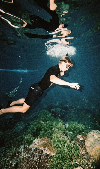 A person swimming underwater. 4