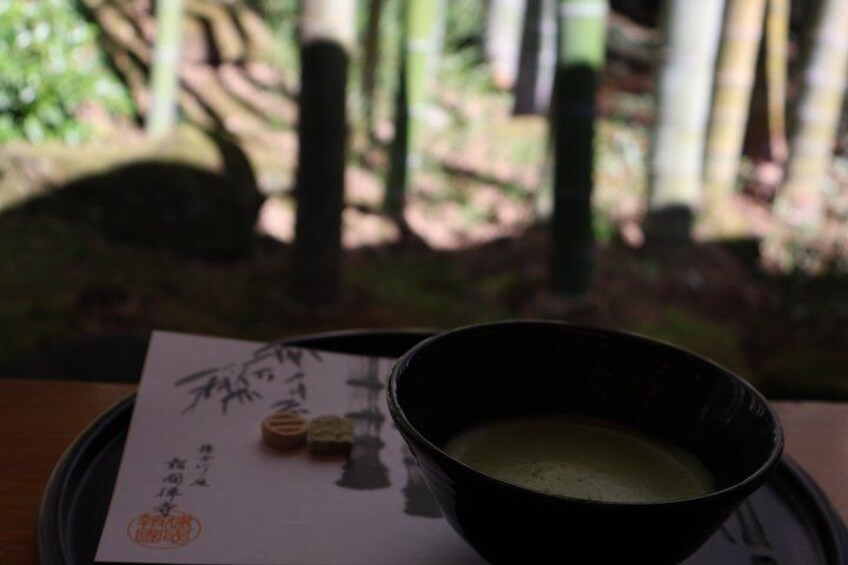 A bowl of soup on a tray with a menu and chopsticks. 5