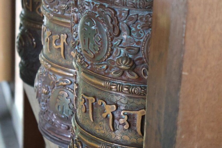 Intricately carved wooden columns with floral and geometric patterns. 2