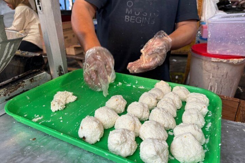 A person preparing food on a green tray. 4