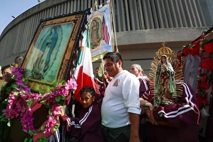 A procession with religious icons, flags, and floral arrangements. 2