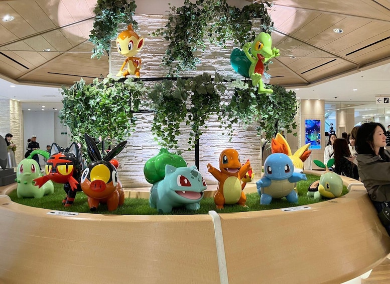 A display of Pokémon characters in a circular arrangement with a central tree-like structure. 1