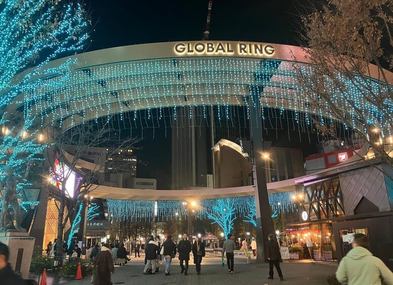 The Global Ring entrance with blue lights and people walking around. 2