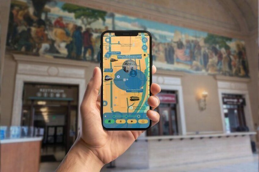 A hand holding a smartphone displaying a map with a blue circle and a yellow square. 3