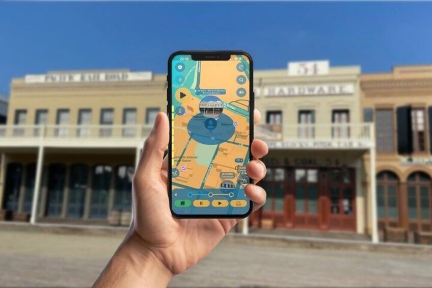 A hand holding a smartphone displaying a map with a blue icon, in front of a building with a sign that reads '51'. 4