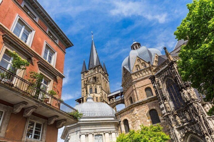 A historic building with a prominent tower and dome, surrounded by other buildings. 3