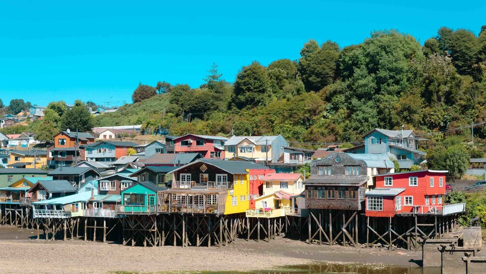 A coastal village with colorful wooden houses on stilts. 4
