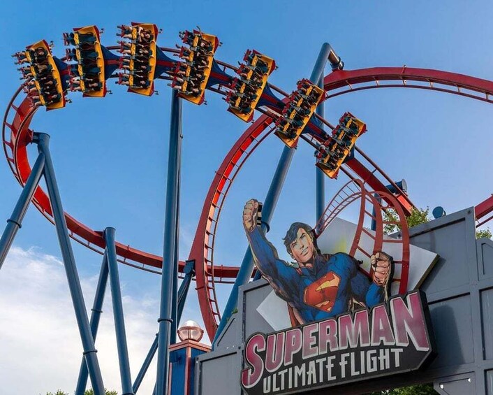 A Superman-themed roller coaster with a sign reading 'Superman Ultimate Flight'. 3