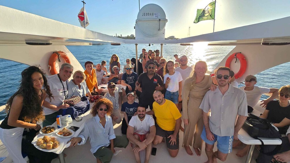 A group of people on a boat with life jackets and a radar dome. 2
