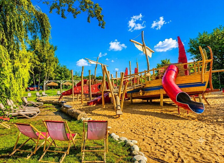 A playground with a slide and climbing structures. 4