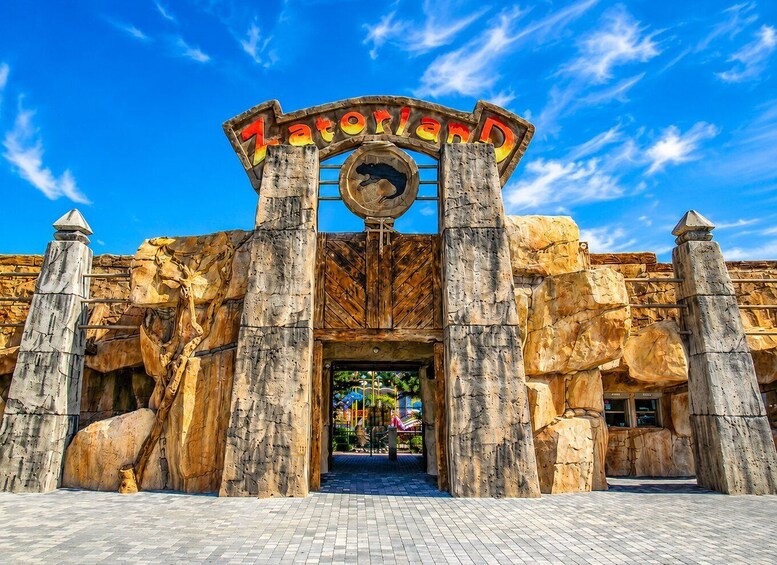 A large entrance with a sign reading 'Zatoland' and a dinosaur silhouette. 1