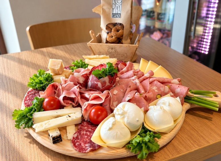 A charcuterie board with various meats, cheeses, and vegetables. 2