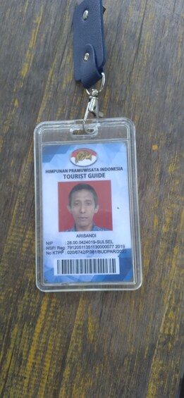 A tourist ID card with a photo, name, and identification numbers. 4