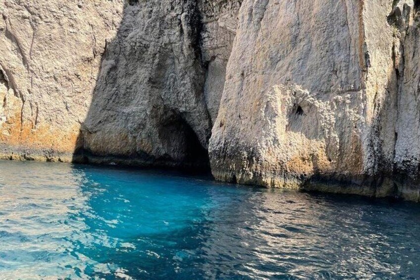 A rocky coastline with a clear blue sea. 5