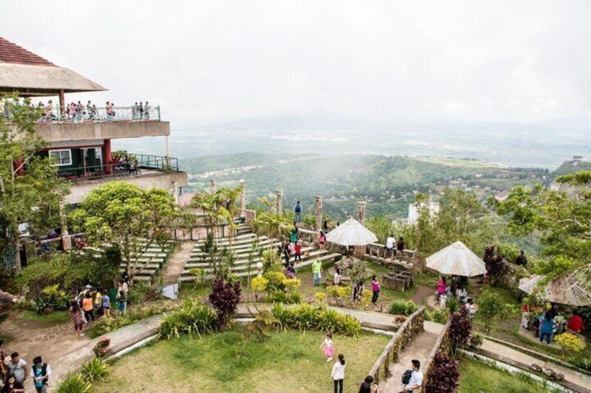 A garden with pathways, a gazebo, and a view of the landscape. 4