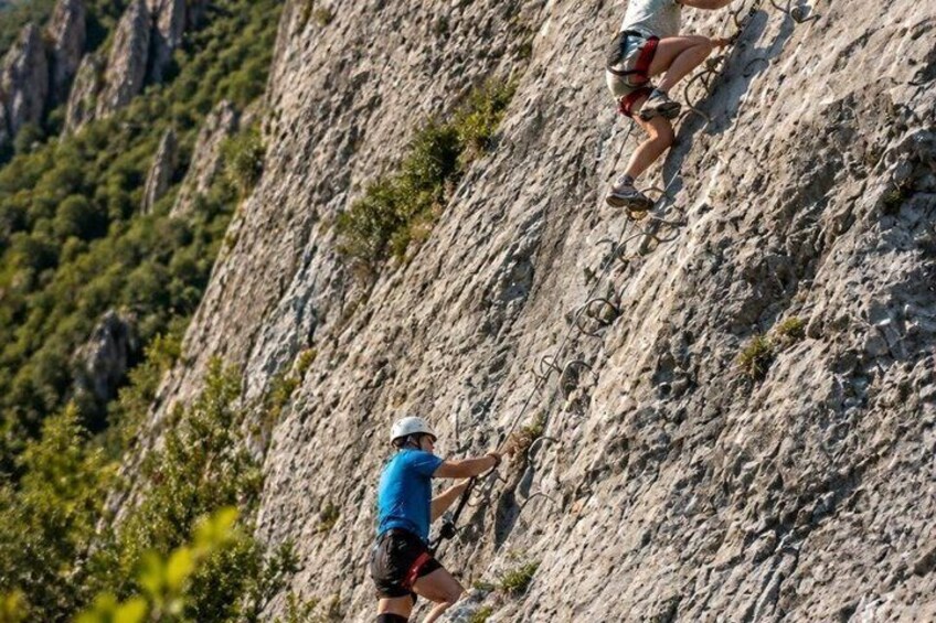 A person climbing a rocky mountain. 5