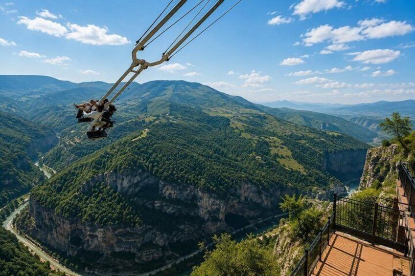 A cable car system with passengers, a mountainous landscape, and a river below. 3