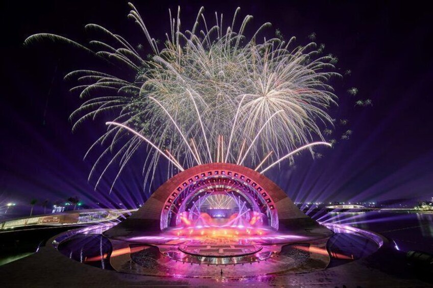 A fireworks display with a circular structure and a fountain. 3