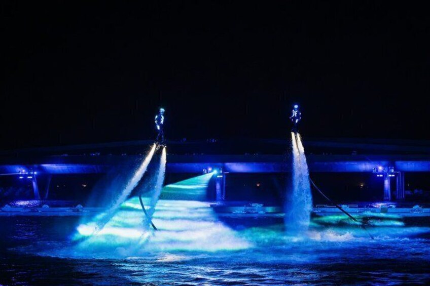 A nighttime water fountain show with illuminated water jets. 5