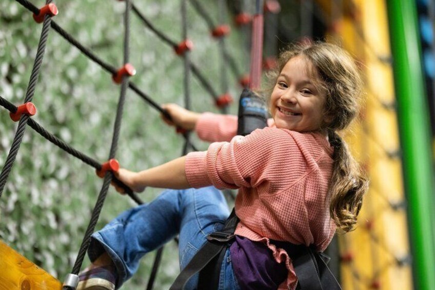 A child climbing a rope net structure. 2