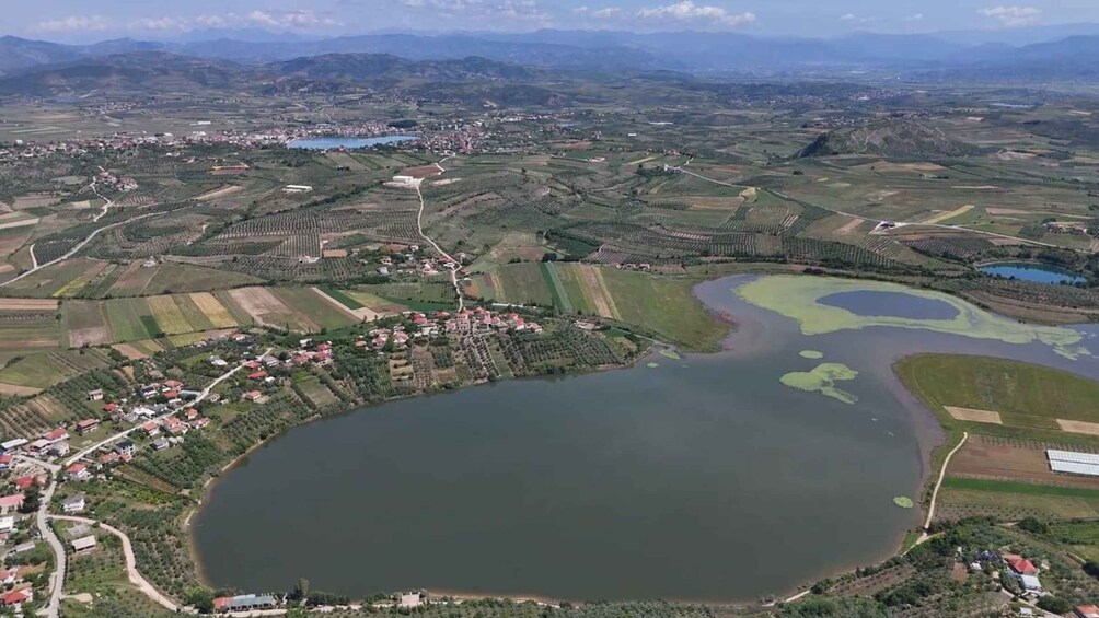 A large lake surrounded by agricultural fields and a small town. 5