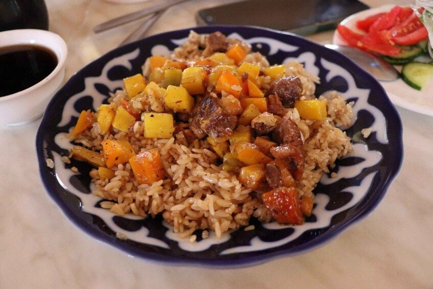 A plate of rice with vegetables and meat. 4