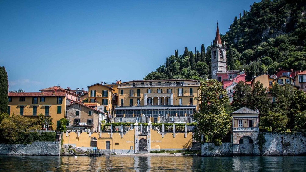 A coastal town with a prominent church, a bell tower, and a waterfront. 4