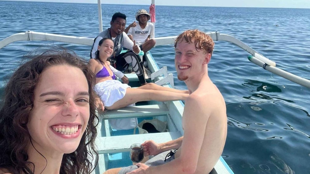 A group of people on a boat in the ocean. 5