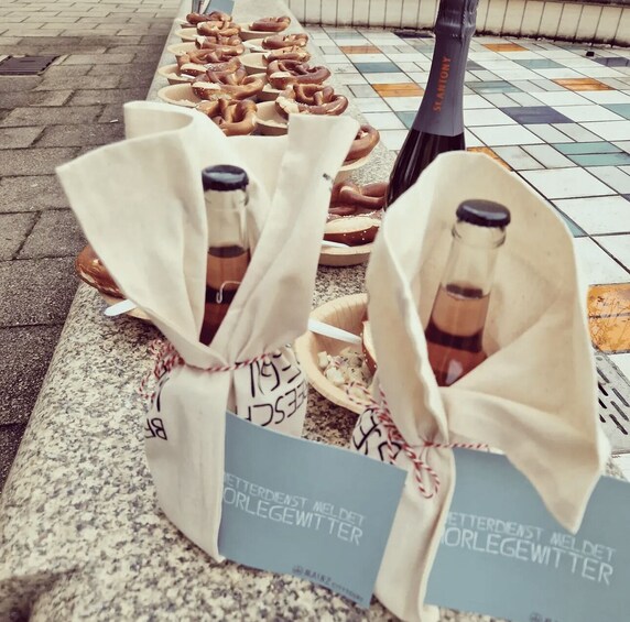Pretzels and bottles on a tiled floor with signs. 3