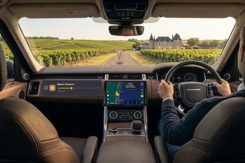A car interior with a digital display, steering wheel, and leather seats. 1