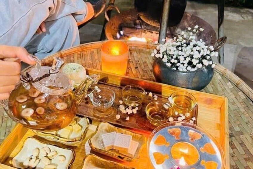 A tray with various tea glasses, a candle, and a pot with flowers. 2