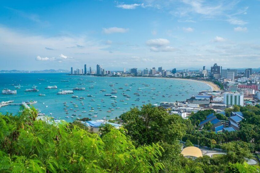 A coastal cityscape with a beach, boats, and dense urban buildings. 2