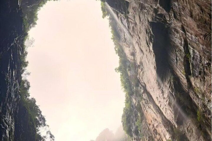 A canyon with steep rock walls and a narrow opening. 5