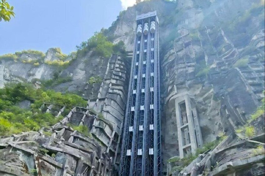 A tall, narrow rock formation with a metal structure attached to it. 2