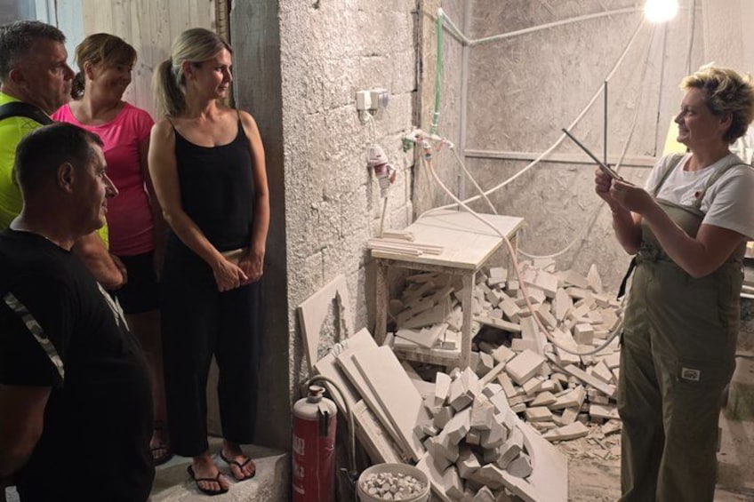A workshop with people observing a demonstration. 2