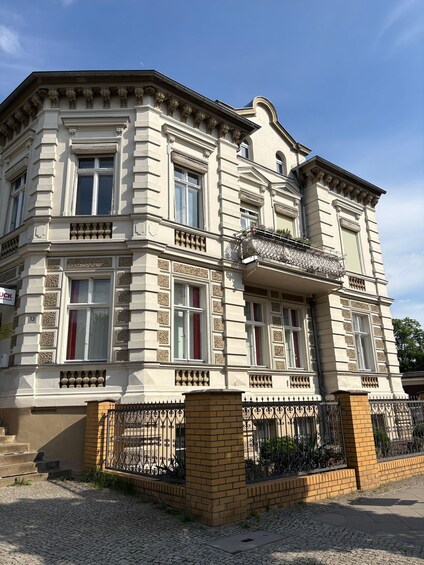A historic building with ornate architectural details, including decorative windows and a brick base. 2