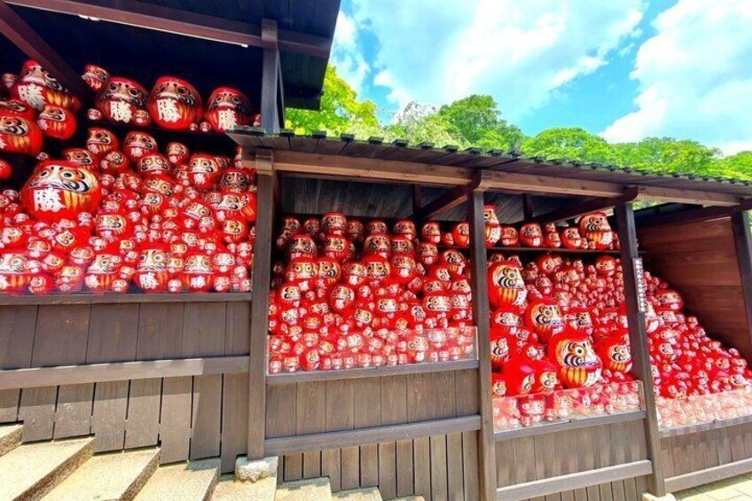 A wooden structure with shelves filled with red lanterns. 1