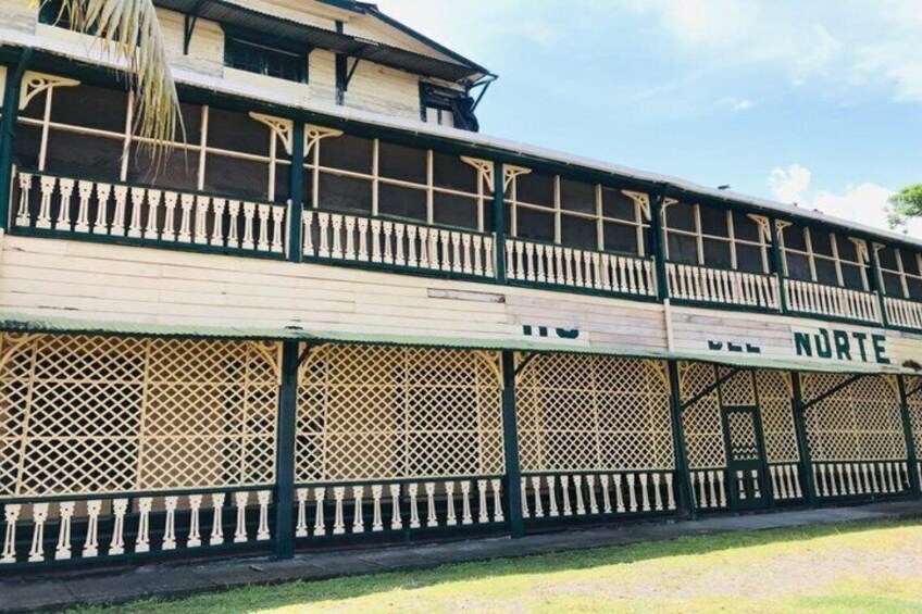 A two-story building with balconies and a sign that reads 'VELL NURTE'. 4