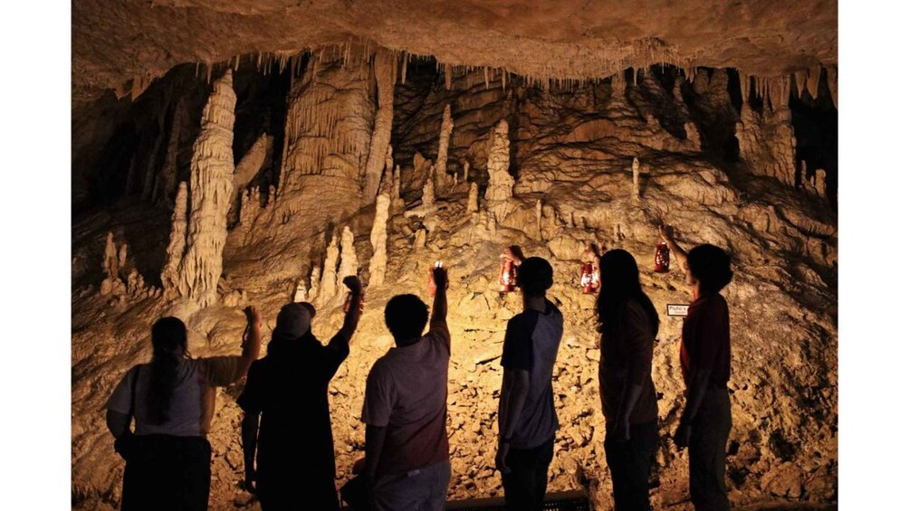 A group of people observing cave formations. 1