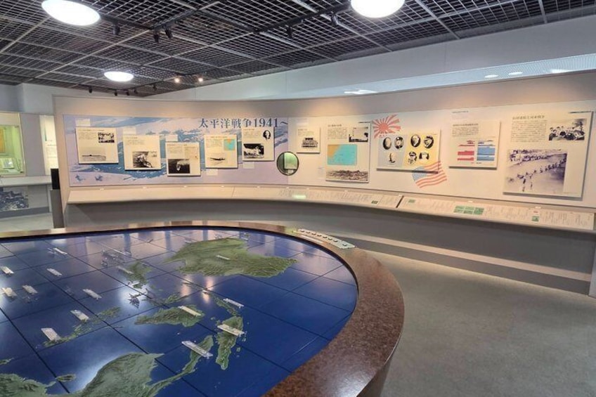 A museum exhibit with a large interactive map and informational displays. 4