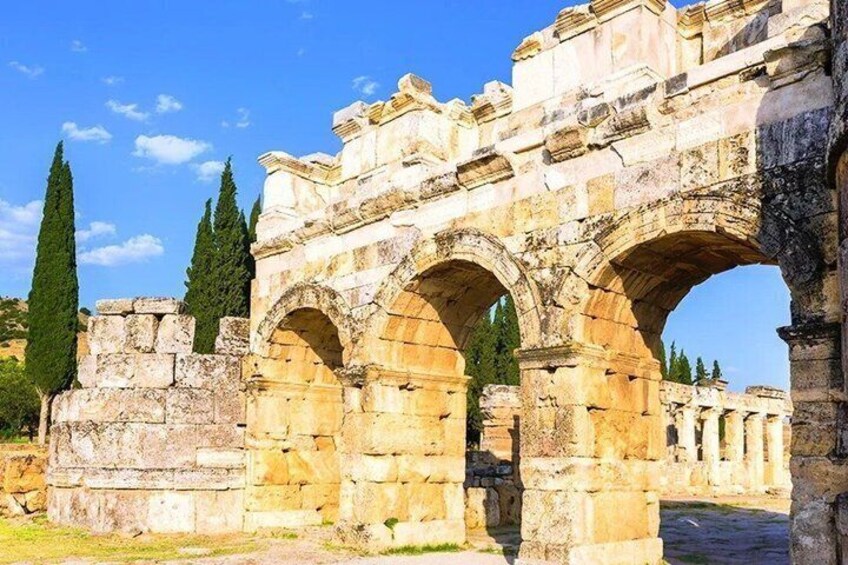 Ancient stone arches and columns, likely part of a historical site. 5