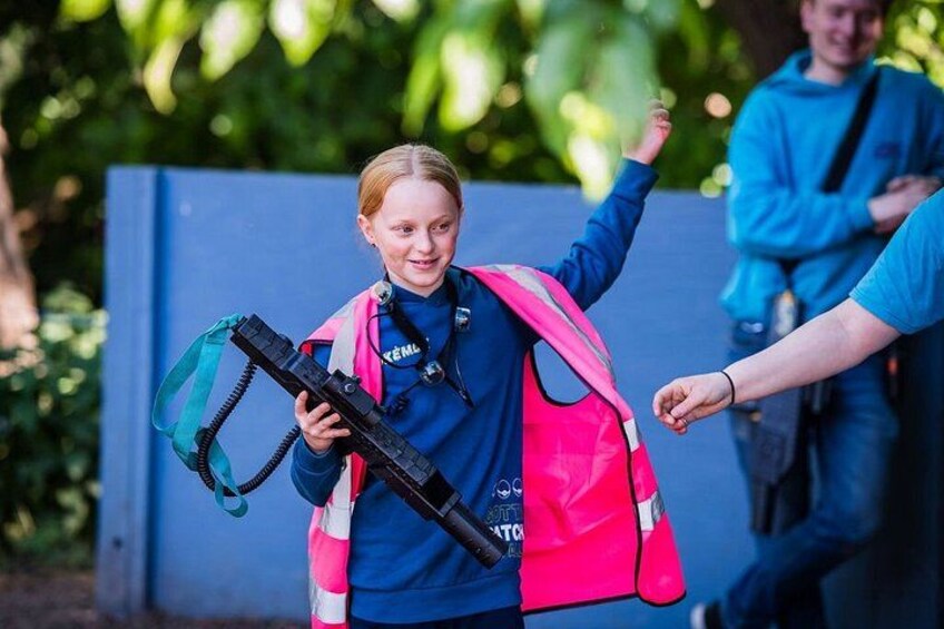 A child with a backpack and a snorkel, walking outdoors. 4