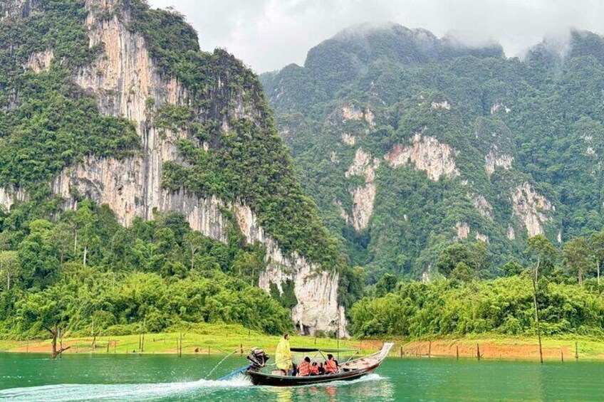 A boat on a river with cliffs in the background. 4