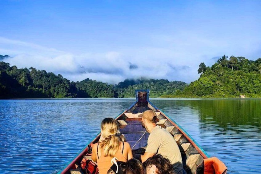 A canoe on a calm lake with a forested shoreline. 3