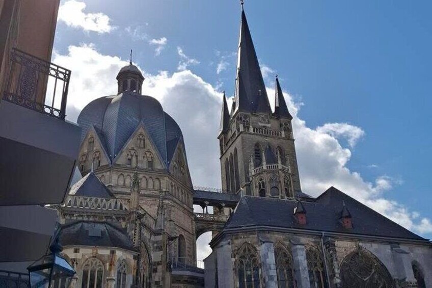 A historic church with a prominent dome and a tall spire. 1