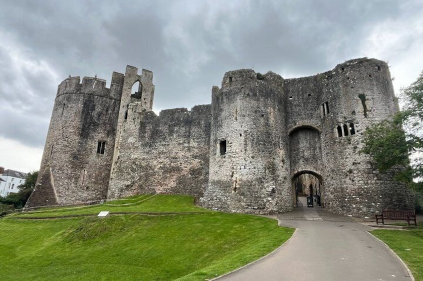A large, historic stone castle with multiple towers and a central entrance. 5