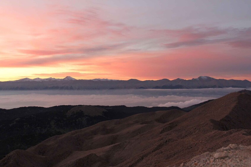 A mountainous landscape with a sunset sky. 3