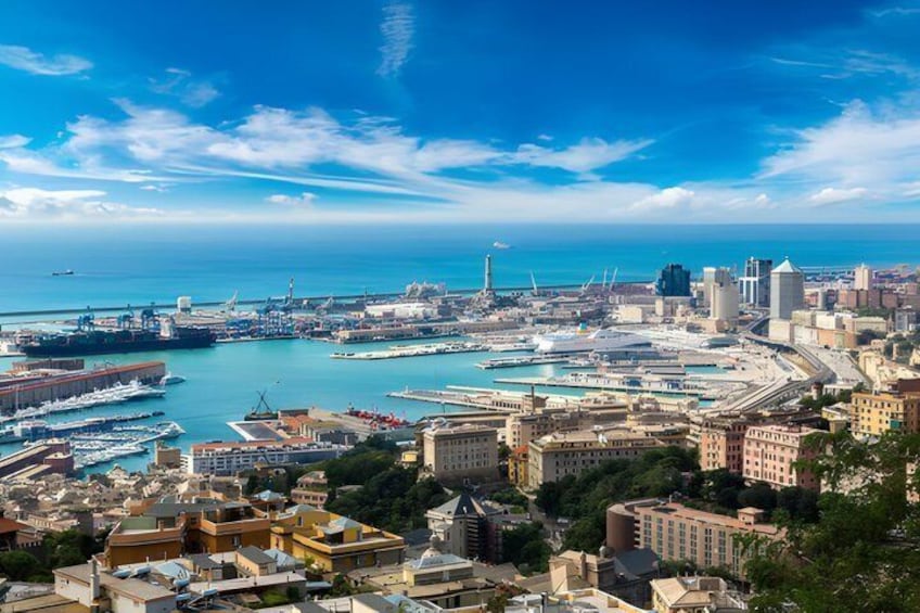 A coastal cityscape with a marina, buildings, and a clear blue sky. 3