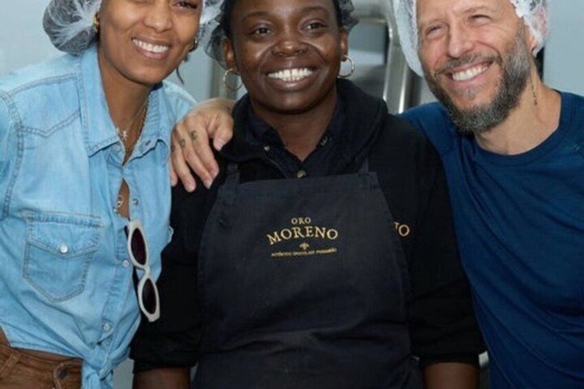 Three people wearing aprons with 'MORENO' on them. 3